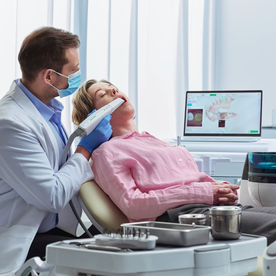 dentist-using-intraoral-scanner-on-patient