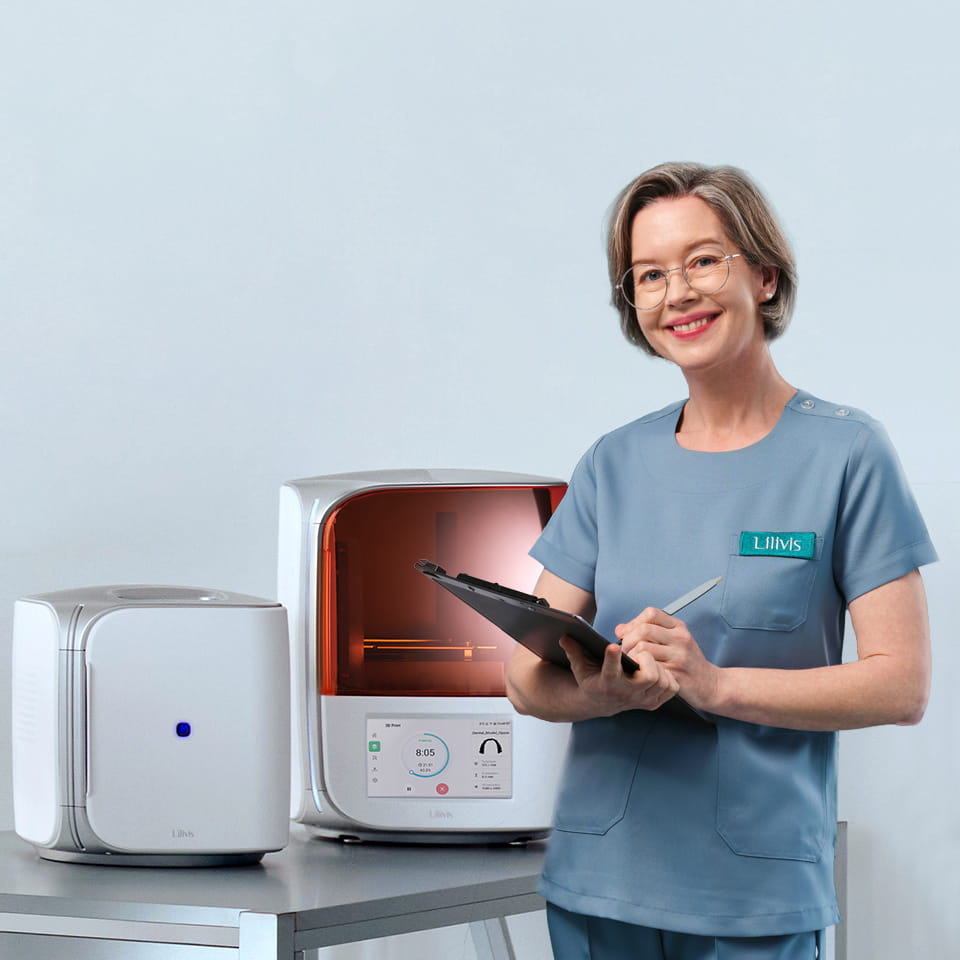 Lilivis PRINT 3D printer and Lilivis CURE machine with a smiling dental clinic professional holding a clipboard.